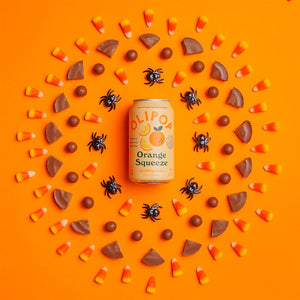 OLIPOP Squeeze Soda surrounded by candy