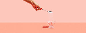 Photo of someone pouring sugar into a cup
